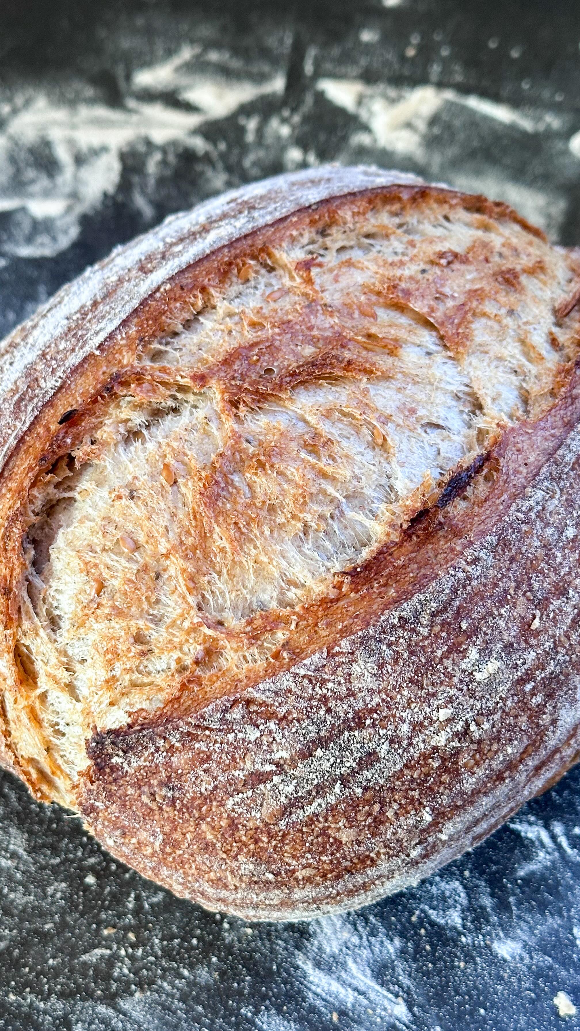 KORNKRUSTE - ein saftiges und kerniges Brot, das ganz ohnehin auskommt.
Werbung. 
Quellstück: 20g Wasser, 8g Chiasamen, 8g Leinsamen
300g Weizenmehl (ich habe 200g Type 00 und 100g Manitobamehl verwendet - 550 funktioniert auch) 
75g Weizenvollkornmehl
80g Sauerteigstarter frisch 
250g Wasser 
8g Salz 
—> das Meer, Wasser und den Sauerteig kurz miteinander verkneten und für 45 Minuten stehen lassen. In dieser Zeit das Quellstück zubereiten und ziehen lassen. Dann das Quellstück und das Salz zum Teig geben und einarbeiten. Den Teig für 3-4 Stunden bei Zimmertemperatur ruhen lassen. In dieser Zeit zwei bis dreimal dehnen und falten. Dann über Nacht im Kühlschrank ruhen lassen.

Am nächsten Morgen das Brot rundformen und in ein Gärkörbchen legen. Dort für nochmals 45 Minuten ruhen lassen. Dann in einem heißen gusseisernen Topf bei 235° Ober- Unterhitze für 30 Minuten mit Deckel, dann für weitere 15 Minuten ohne Deckel backen.

🧑‍🍳 die Chiasamen & Leinsamen verwende ich von @koro_de - hier spart ihr wie immer 5% auf alles mit FRAUHUEGEL. 

#gesundeernährung #gesunderezepte #brotbacken #sauerteigbrot #darmgesundheit